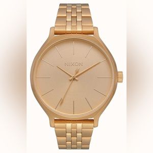 Nixon strainless steel watch in gold